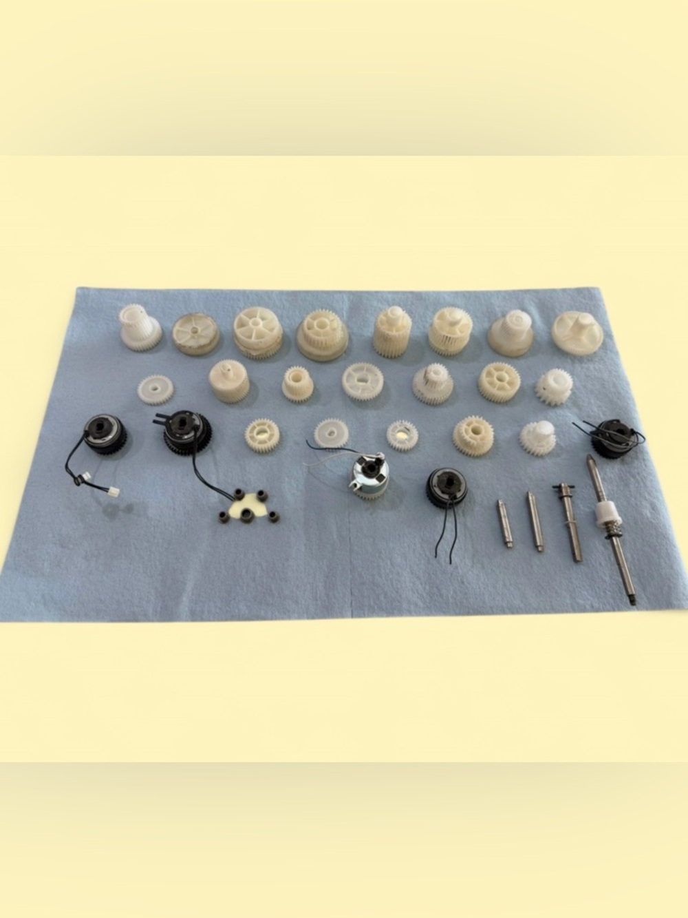 Assorted Plastic Gears and Small Motor Parts - White/Cream for science projects.